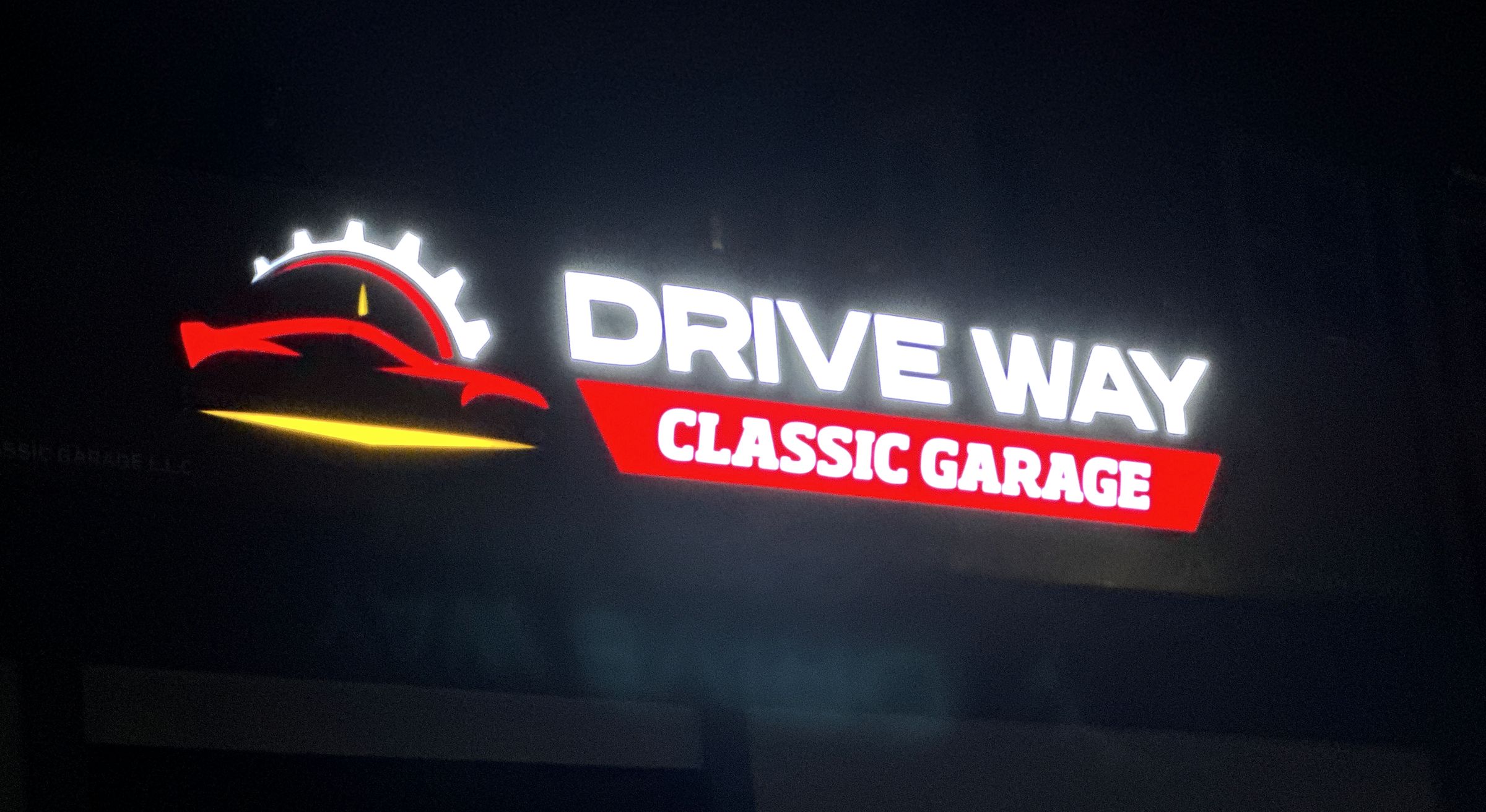 Illuminated Drive Way Classic Garage sign at night